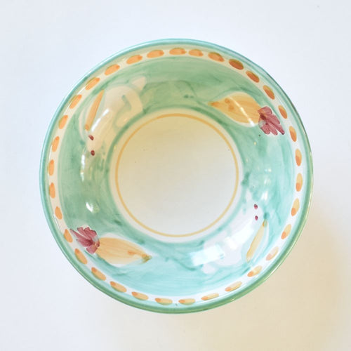 A small green ceramic bowl with a bunny (hare) design and floral accents on the rim.