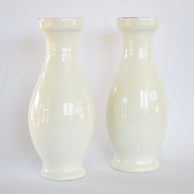 White bottle-shaped pillar candleholders
